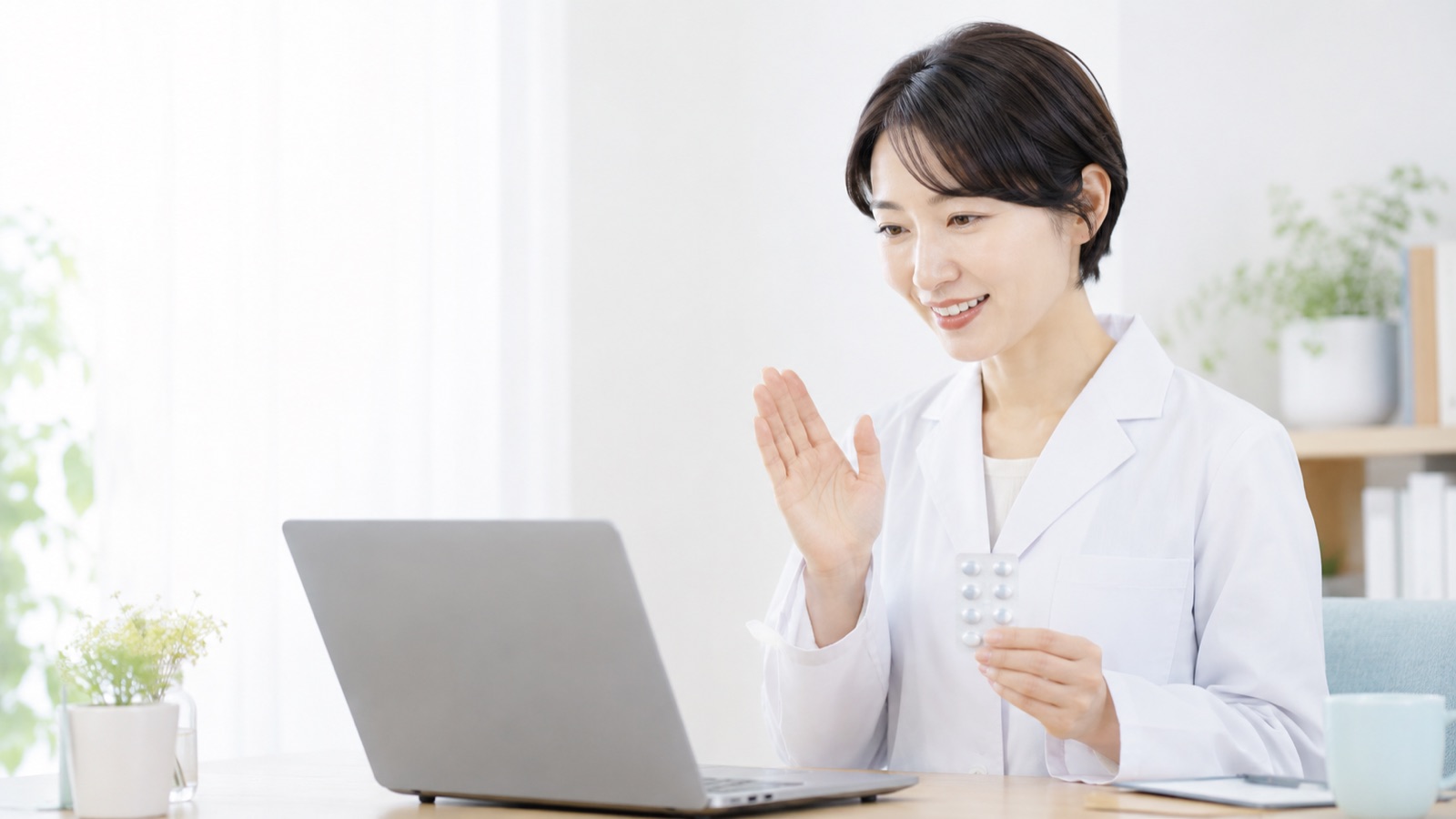 ノートPCの前で説明する薬剤師